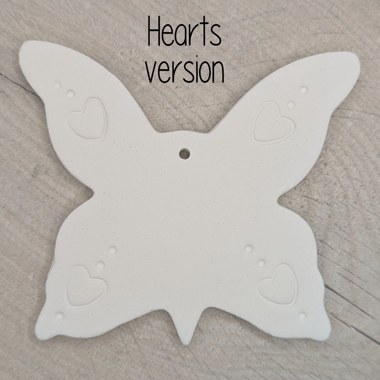 large air dried clay butterfly decoration, with a heart pattern stamped into the wings