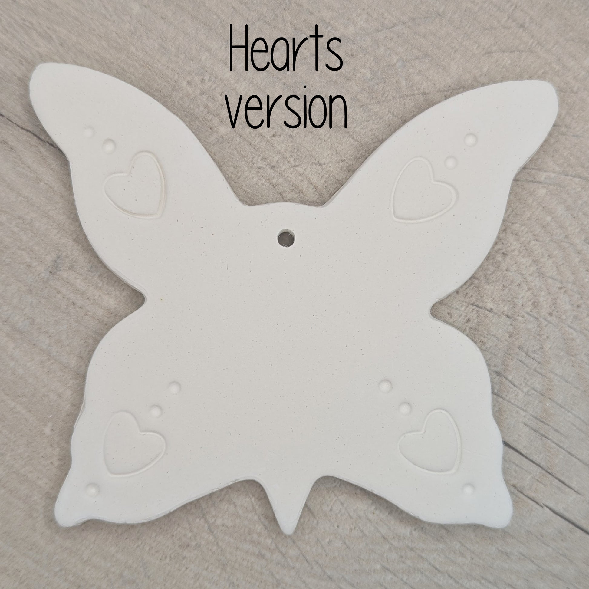 large air dried clay butterfly decoration, with a heart pattern stamped into the wings