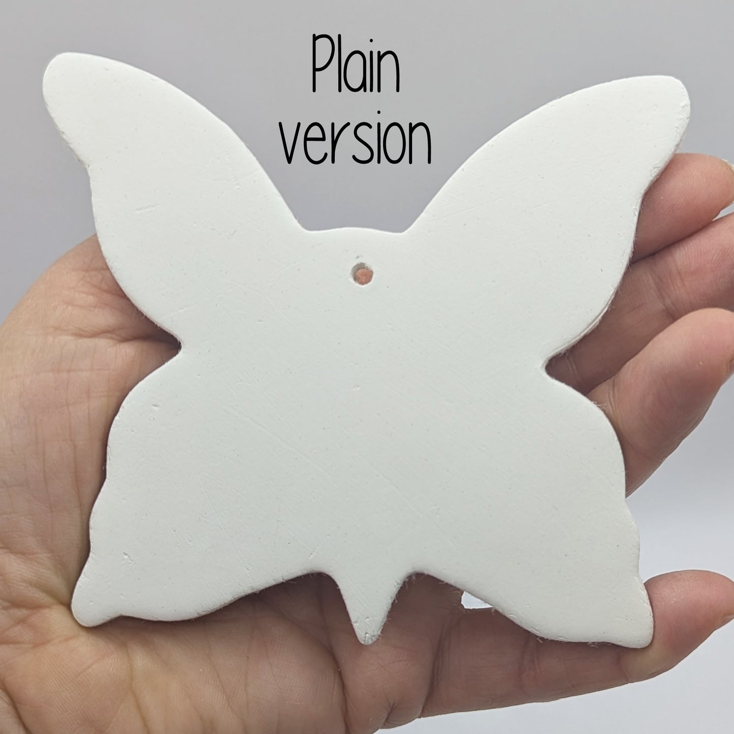large clay plain butterfly decoration in a ladies hand to show scale