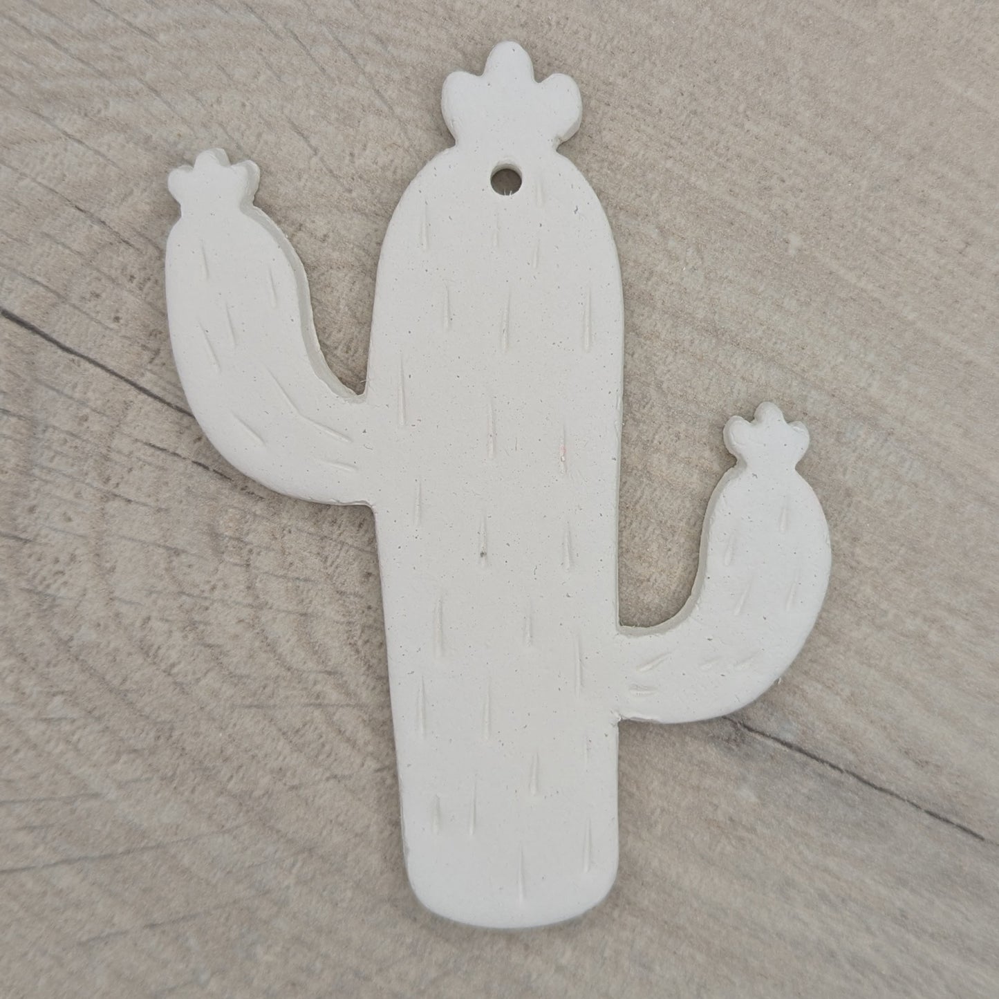 cactus shaped clay decoration, with spike details stamped in