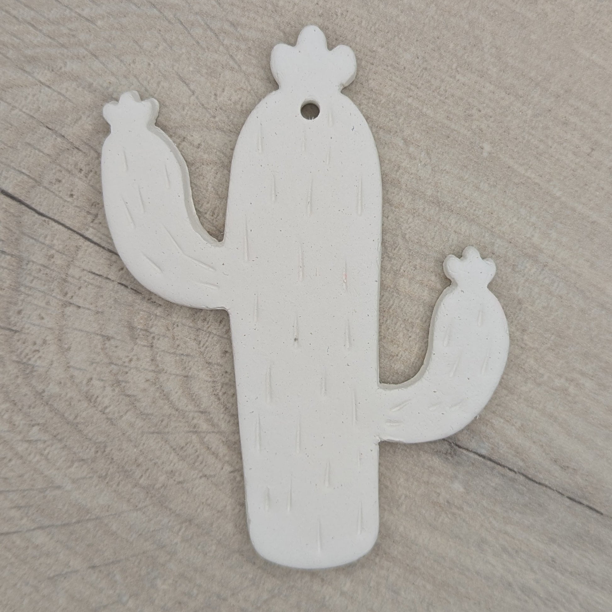 cactus shaped clay decoration, with spike details stamped in