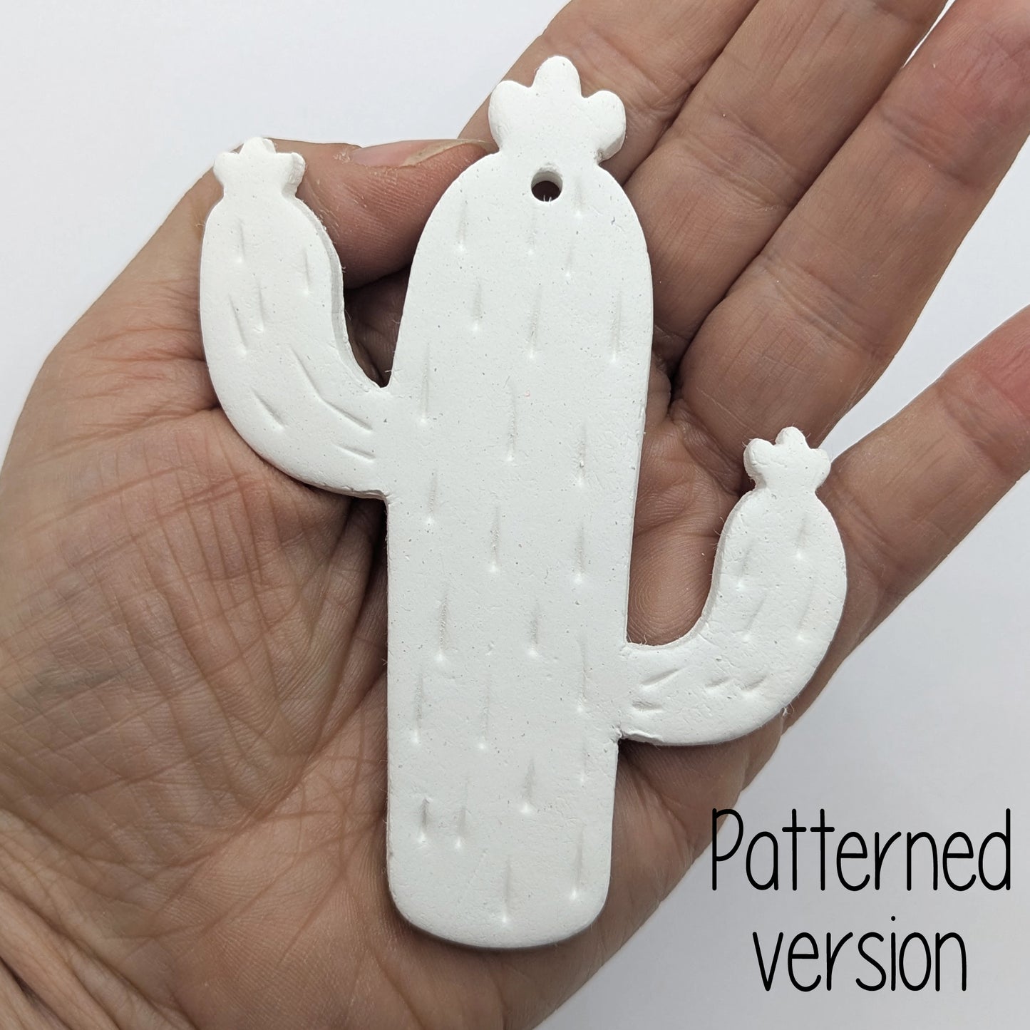 cactus shaped clay decoration, with spike details shown in ladies hand for scale