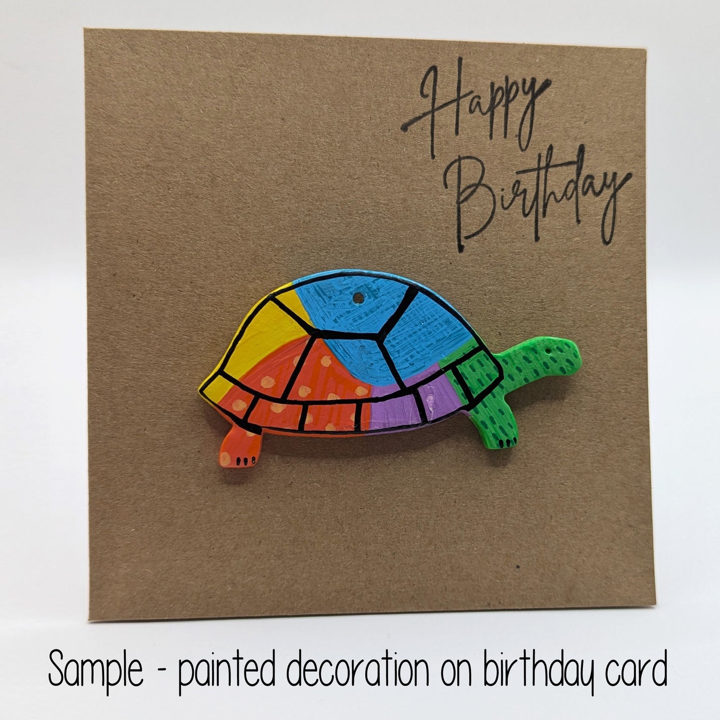 happy birthday card with a colourful tortoise clay decoration on the front