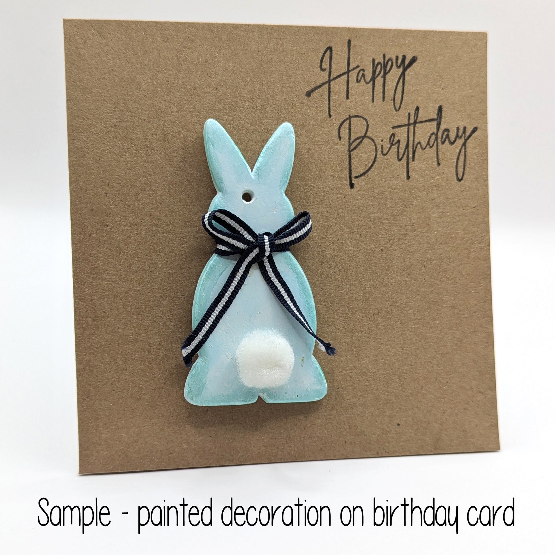 happy birthday card with painted bunny decoration on the front, rabbit has a black bow around neck