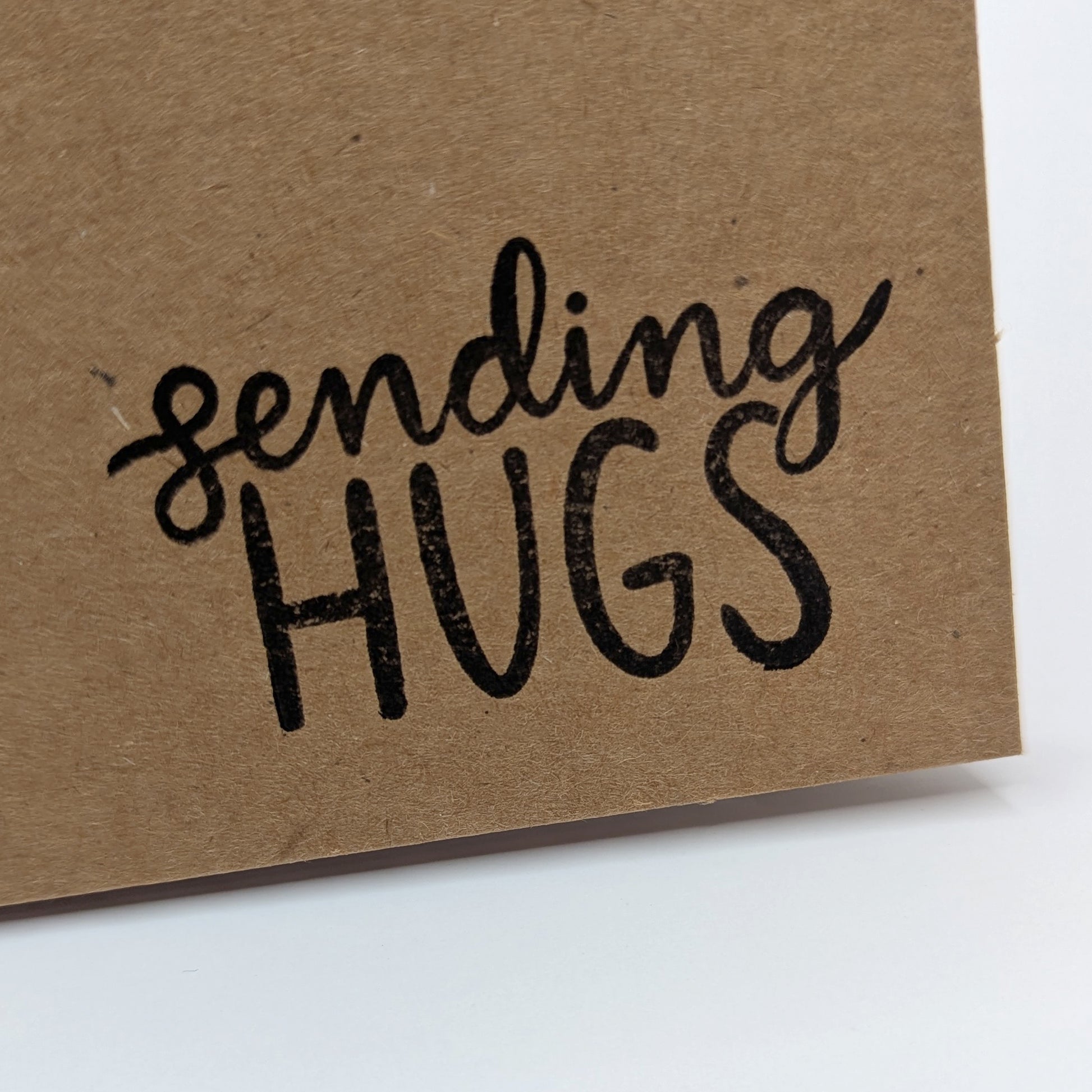 sending hugs stamped onto corner of kraft card