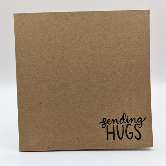 sending hugs stamped onto the corner of kraft card