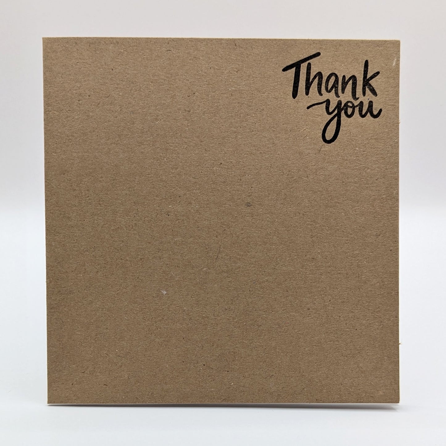 kraft card, with thank you stamped on in black ink
