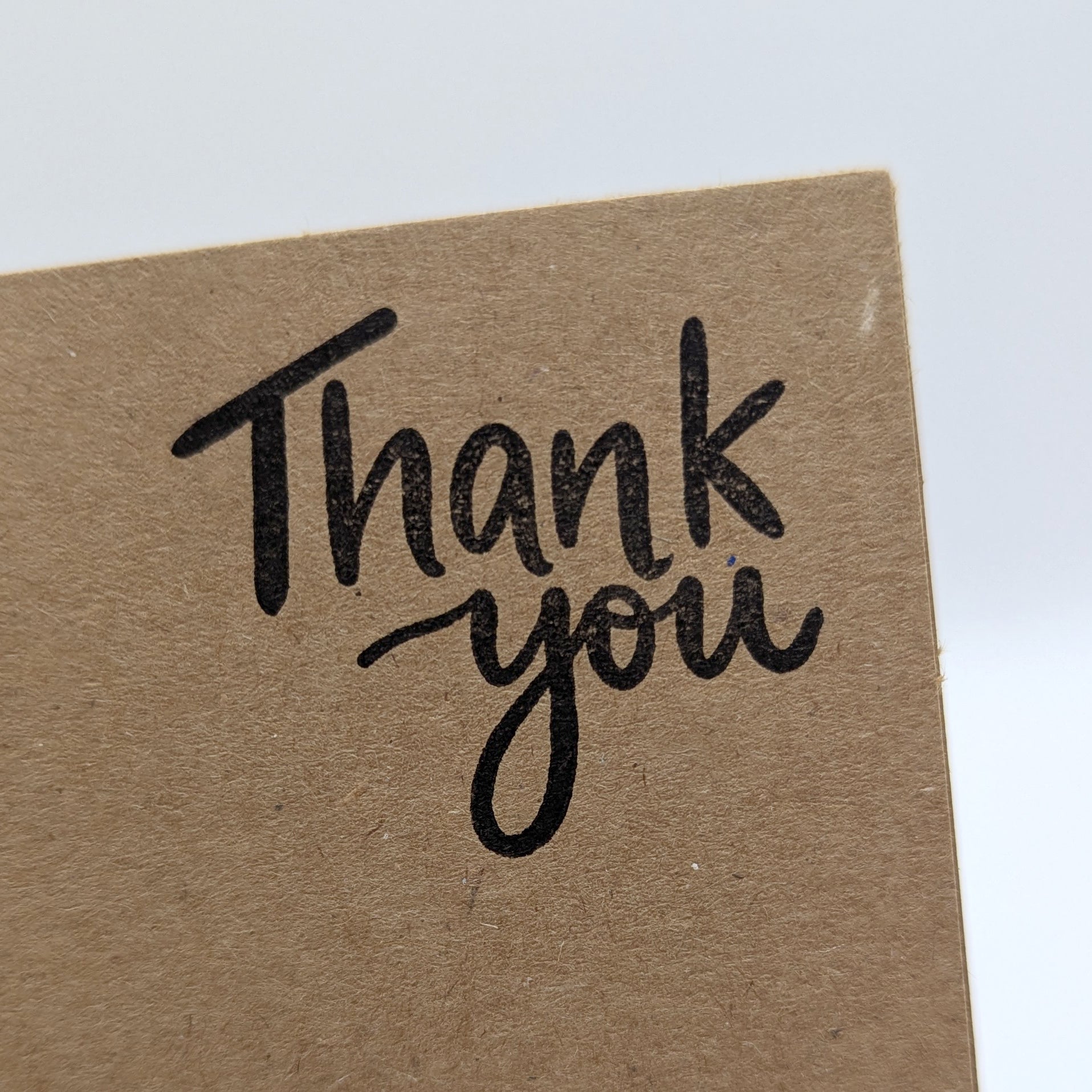corner of the thank you card, black ink stamped on kraft card