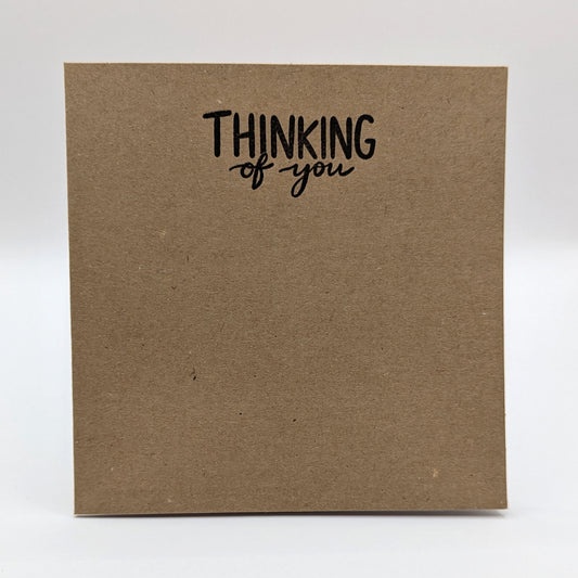 thinking of you stamped in black ink onto a kraft card
