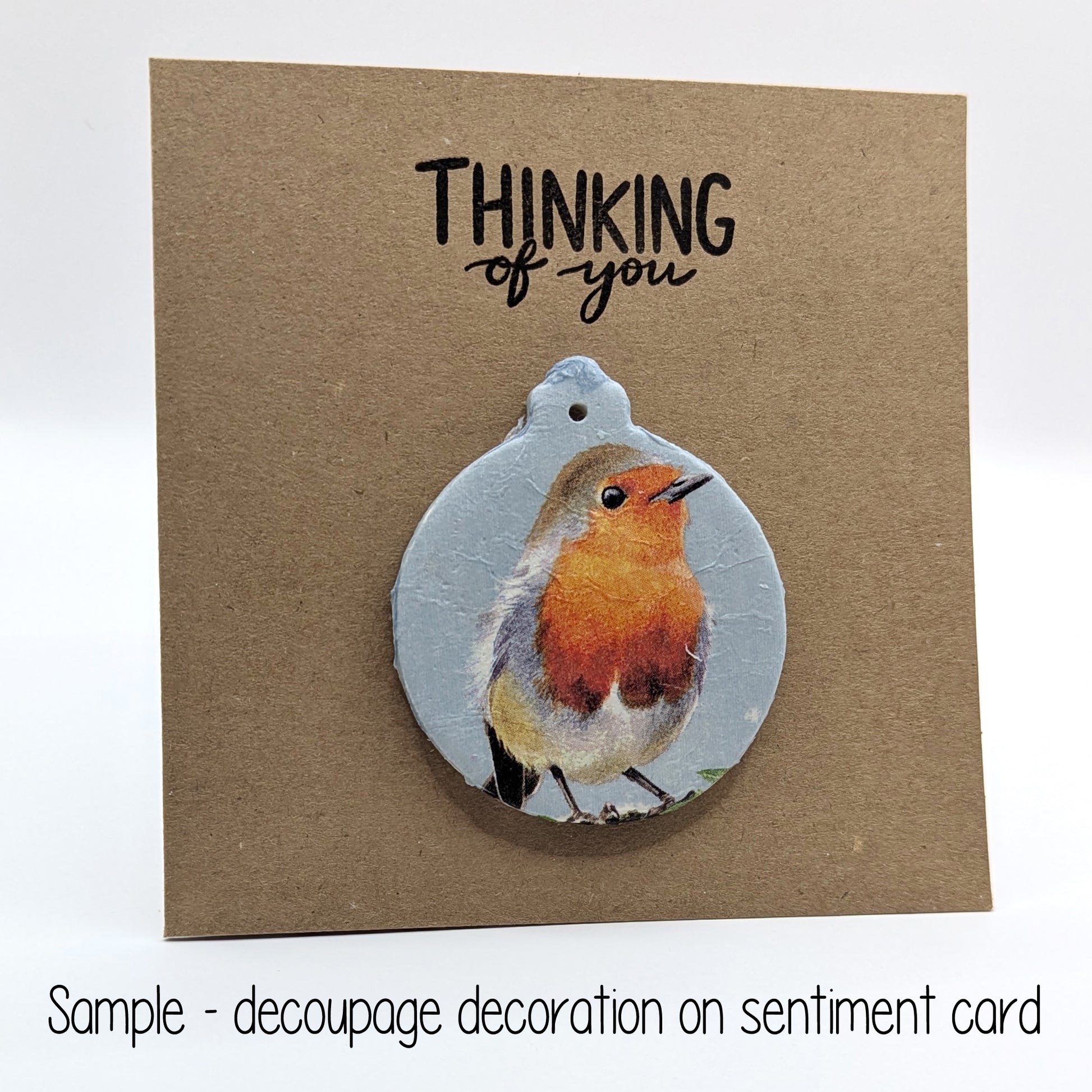 thinking of you card with bauble clay decoration on the front the decoration has a robin on it