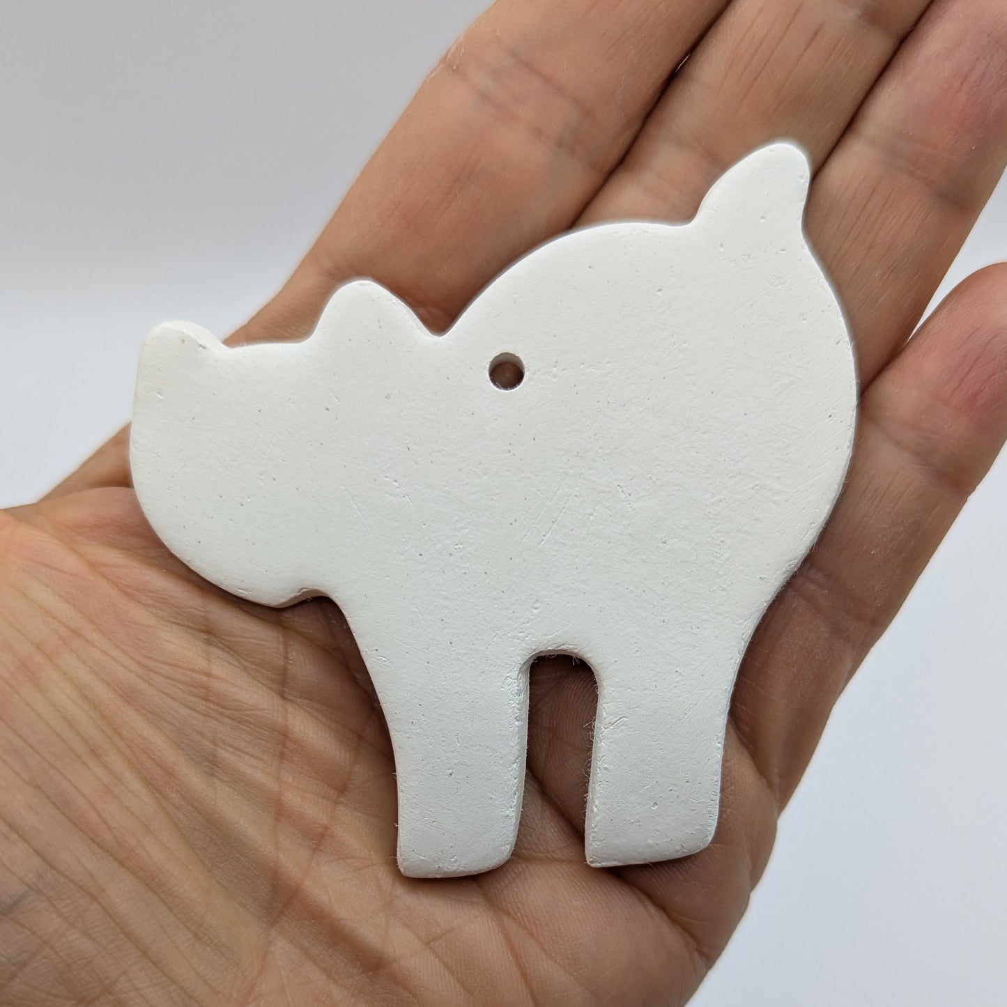 halloween cat decoration being held in the palm of someones hand to show size