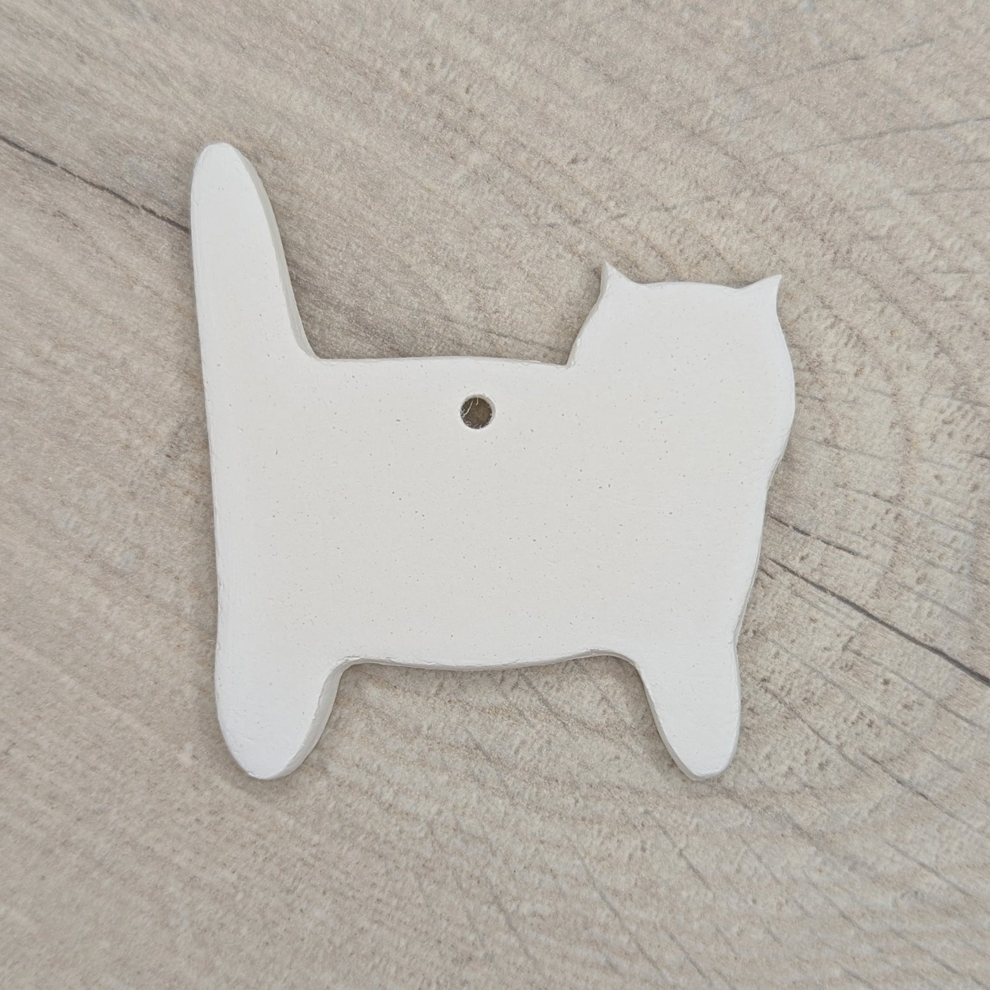 side view of cat, air dried clay decoration to paint and decorate at home or school