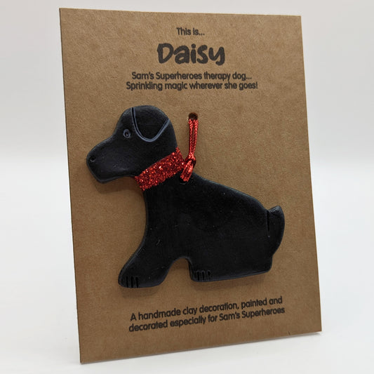 daisy dog Labrador painted black with a red glitter collar, mounted on a kraft backing card, designed for Sam's Superheroes