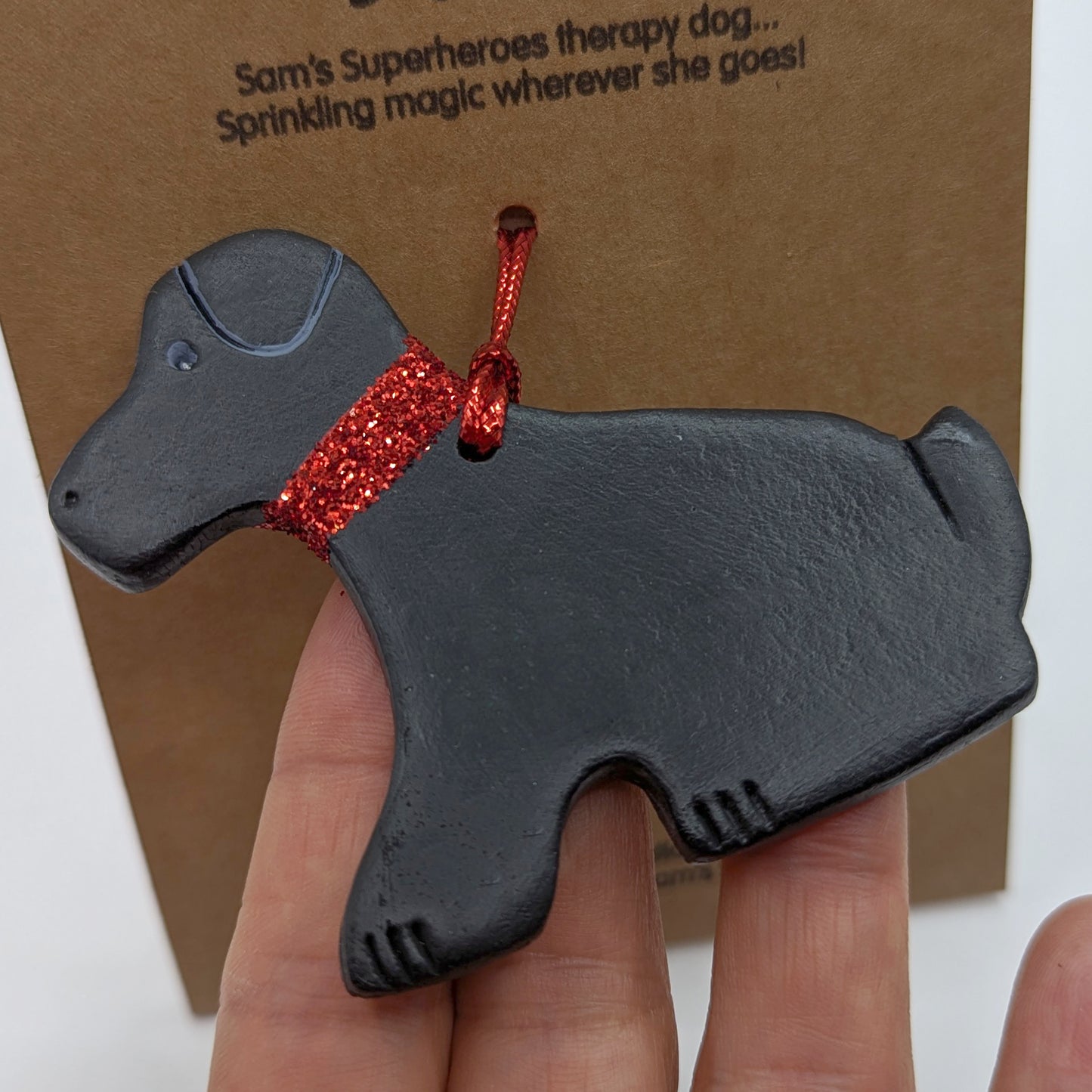 Close up of clay decoration of daisy dog a black Labrador for the charity Sam's Superheroes