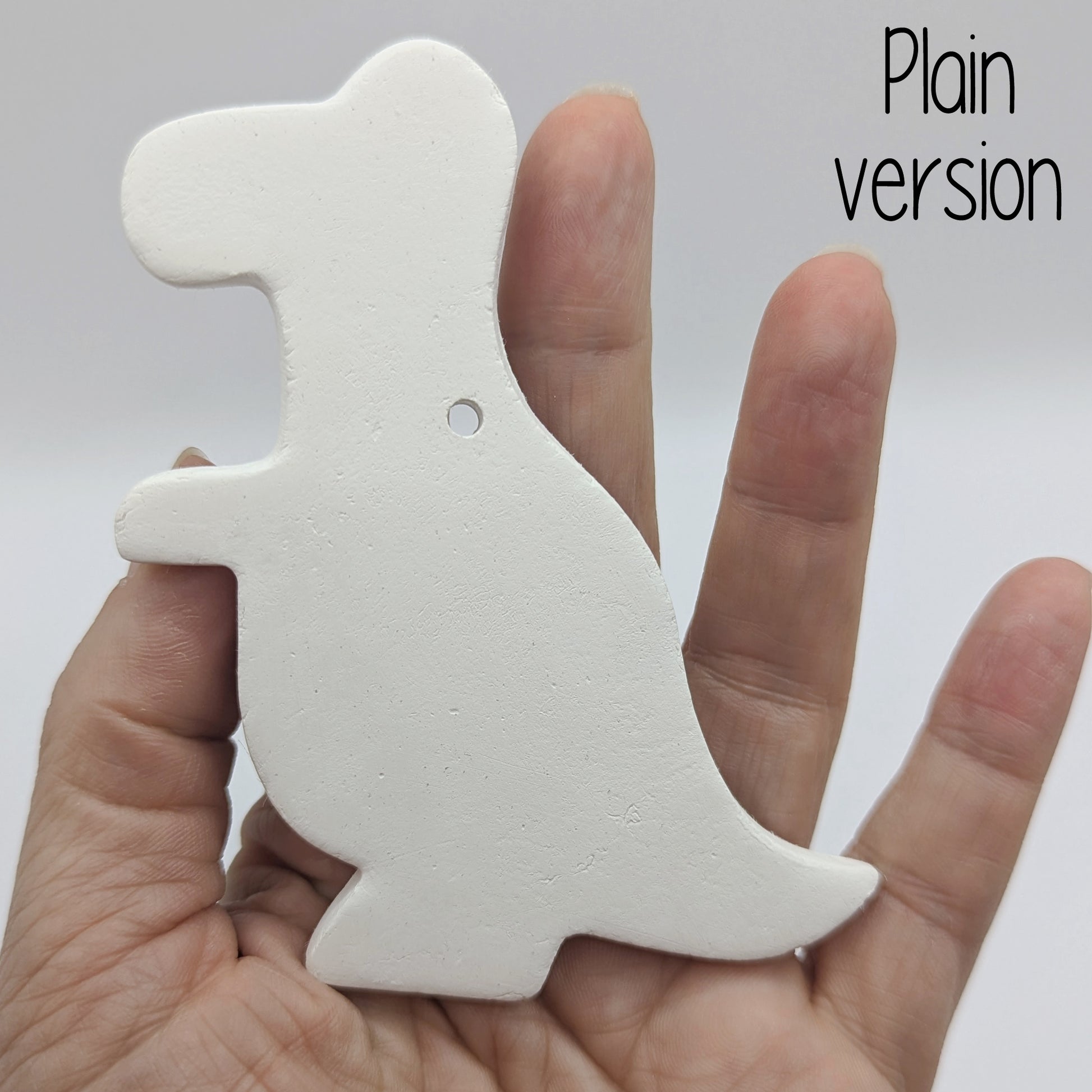 plain Tyrannosaurus dinosaur clay decoration, in ladies hand for scale