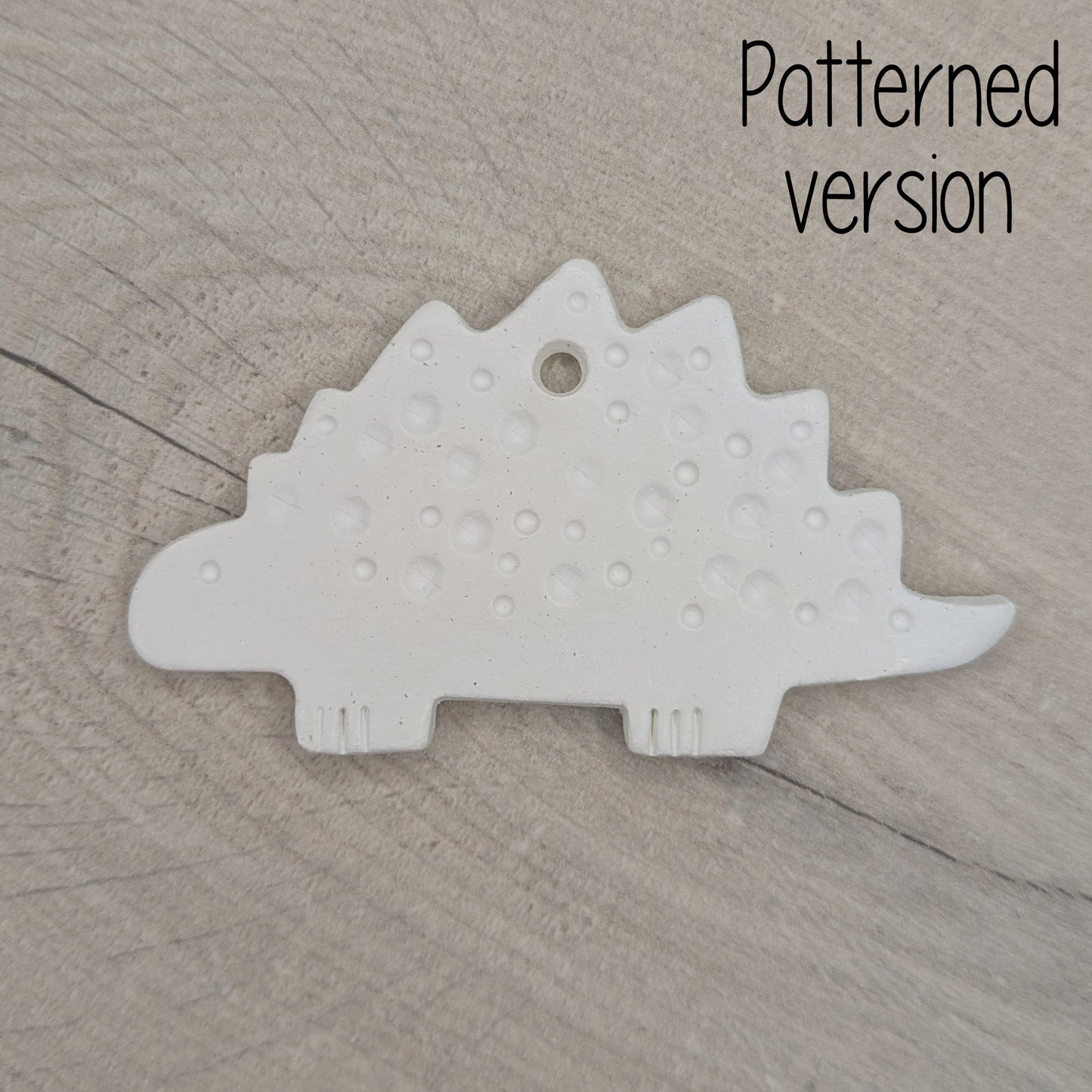 spotted Stegosaurus dinosaur air dried clay decoration, for children and adults to paint at home