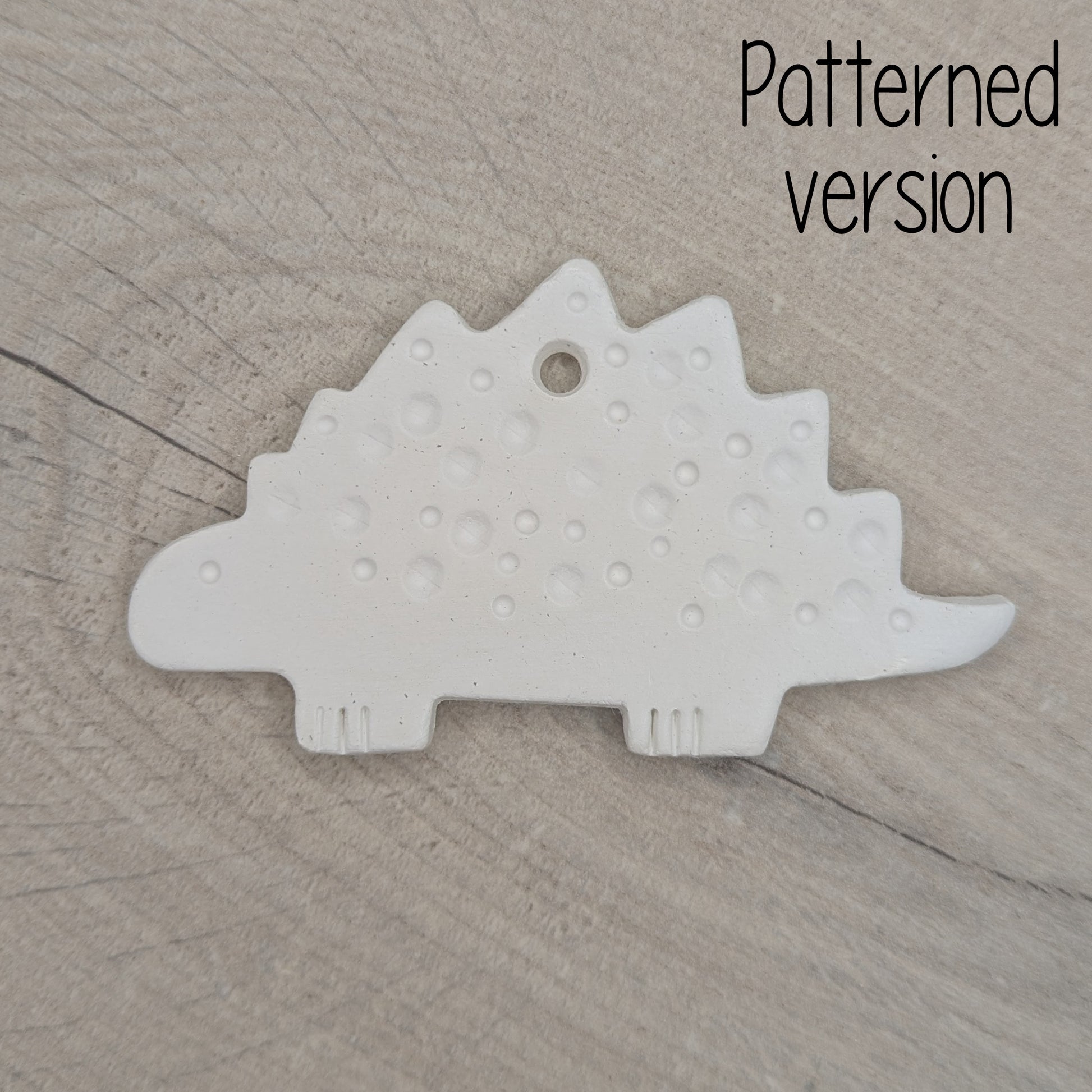 spotted Stegosaurus dinosaur air dried clay decoration, for children and adults to paint at home