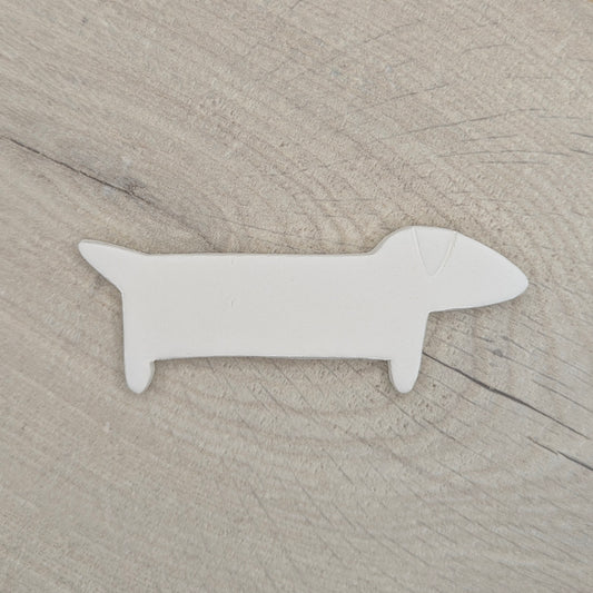 sausage clay decoration shown on a light wood background