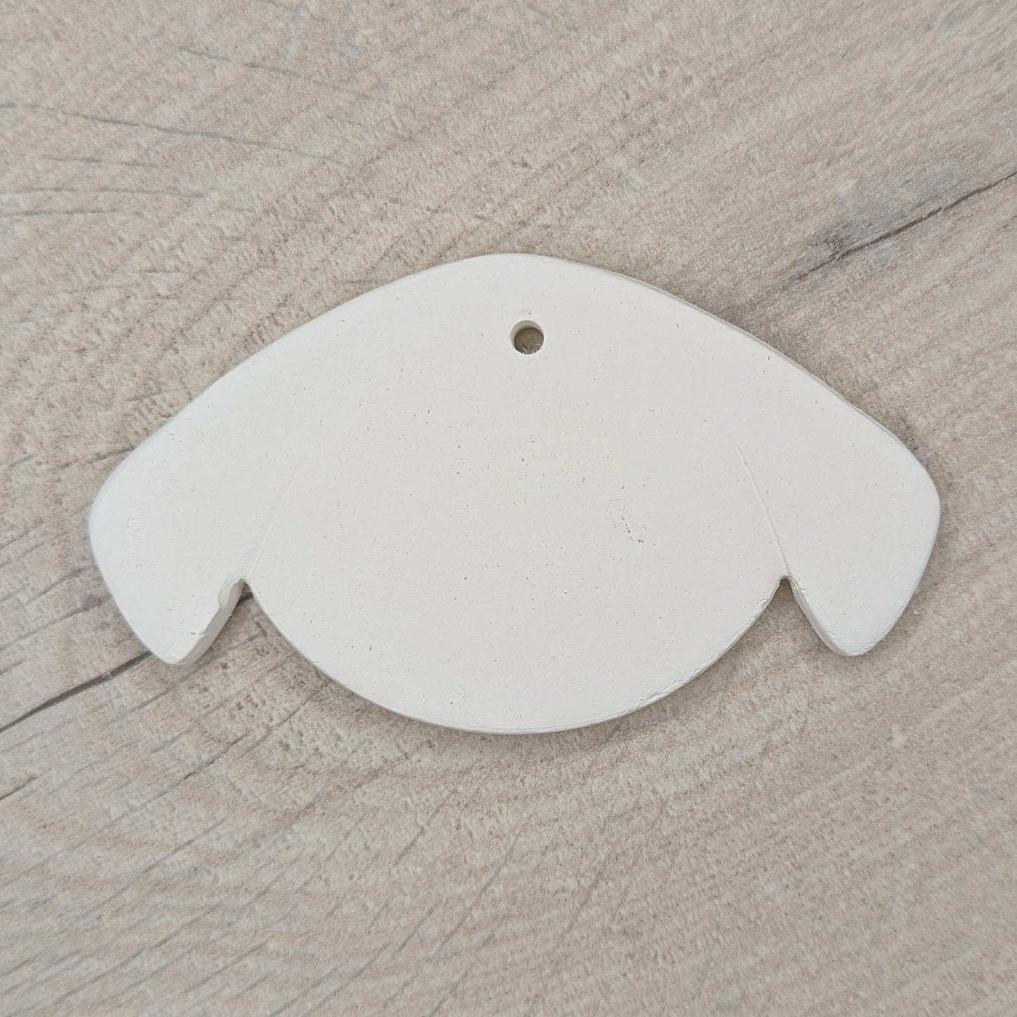 cute dog face clay decoration for you to paint and decorate, dog has floppy ears on side of its face