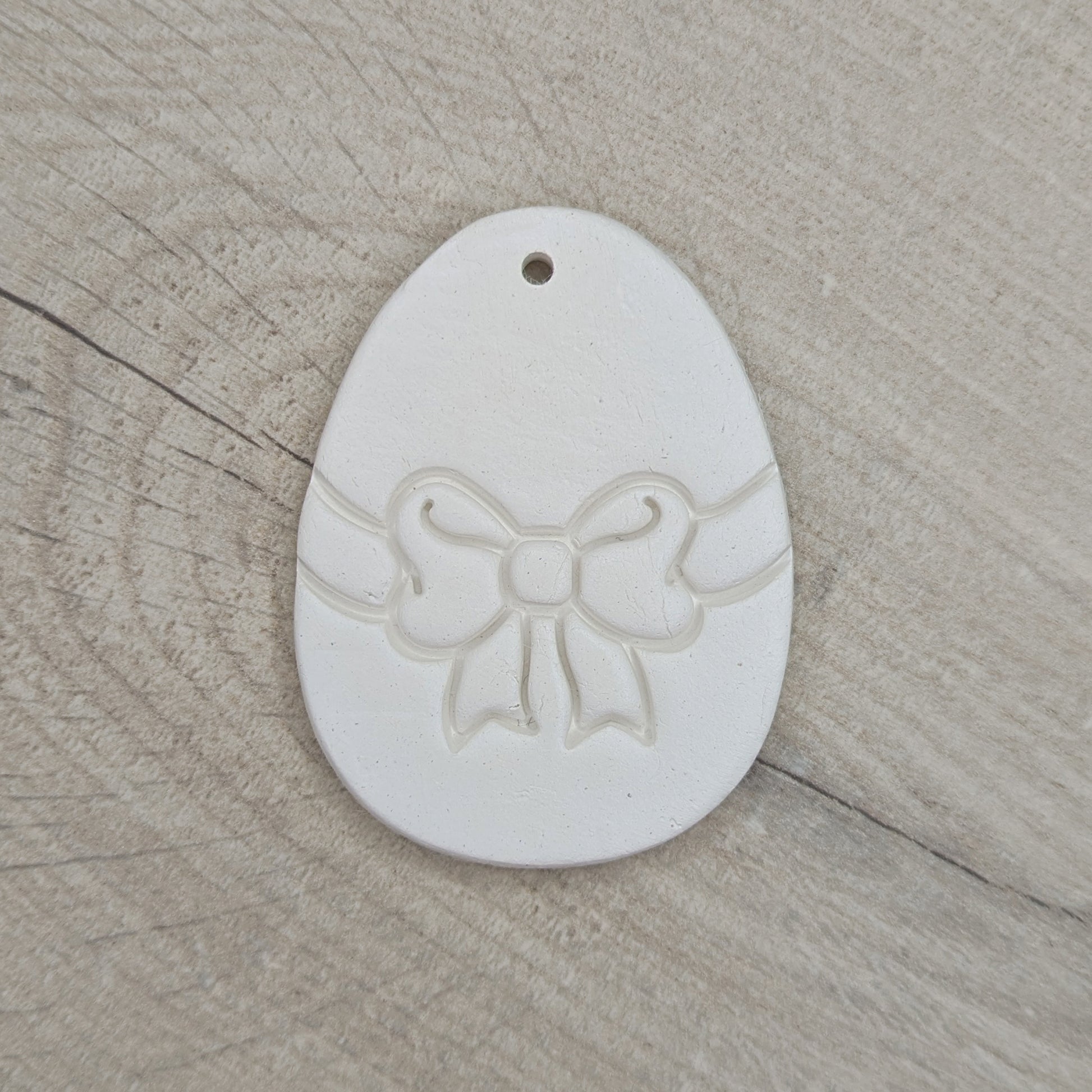 easter egg decoration with a bow design stamped into it