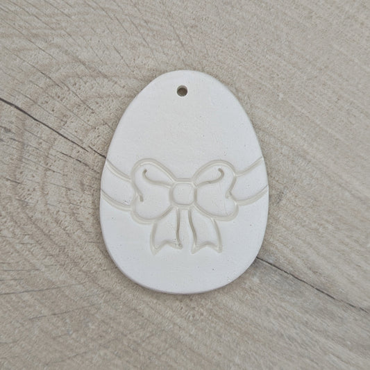 easter egg decoration with a bow design stamped into it