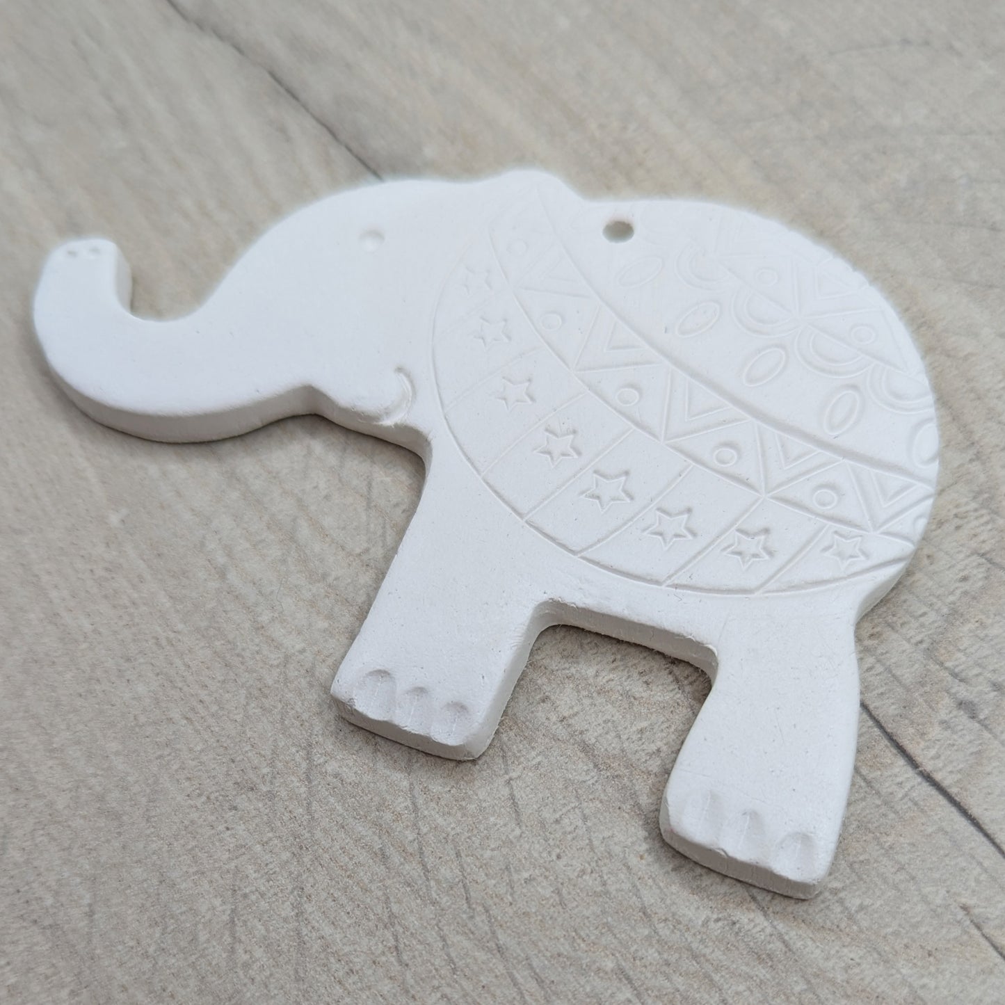 adult clay elephant decoration with a pattern stamped on the back end, also has toe nails, eye, mouth and trunk air hole details