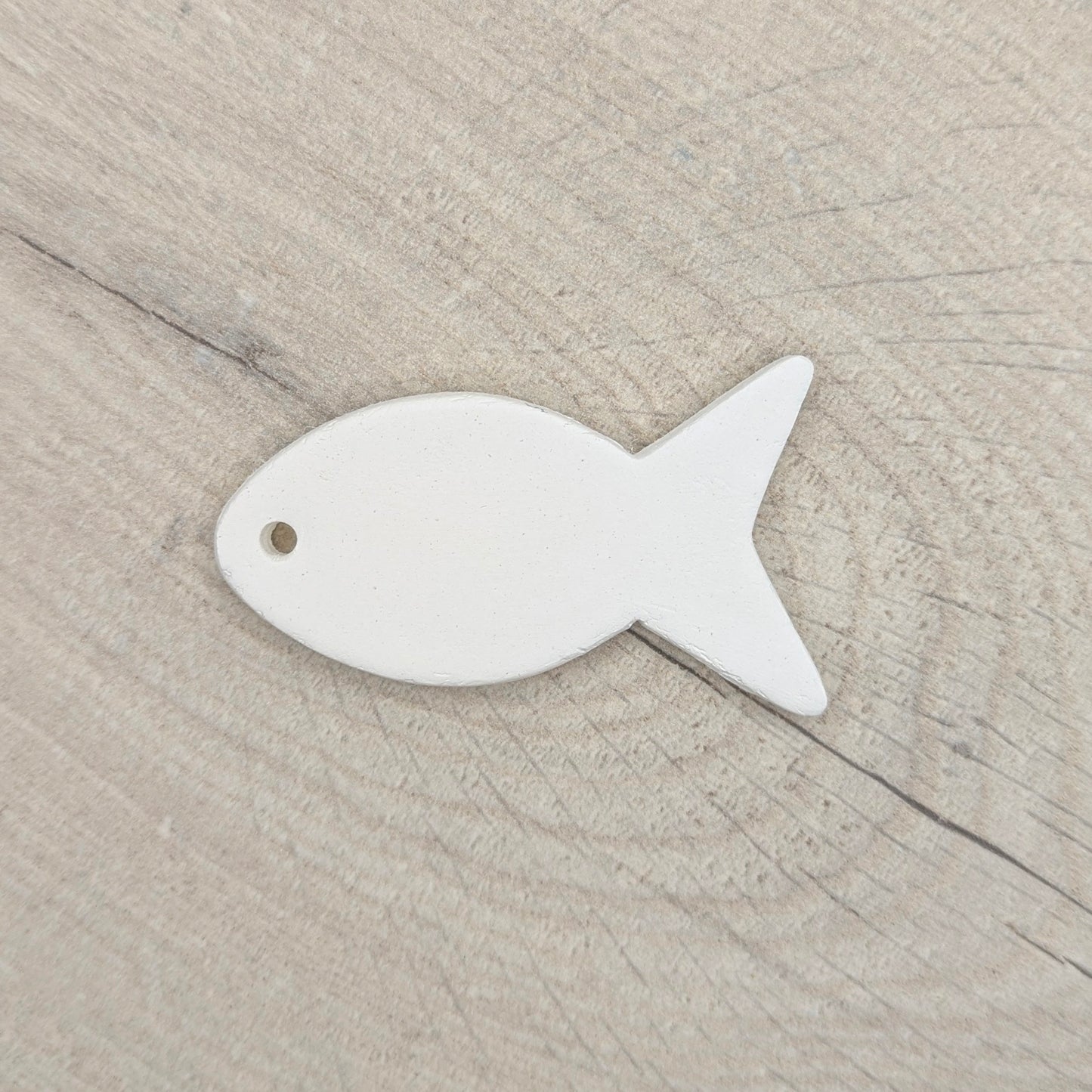 clay decoration shown against a light wood background