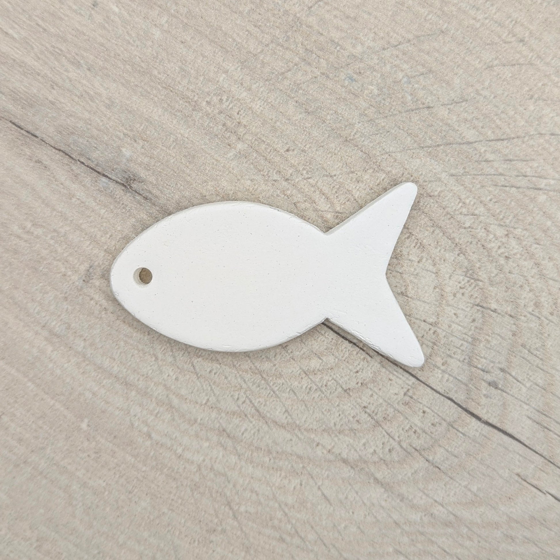 clay decoration shown against a light wood background