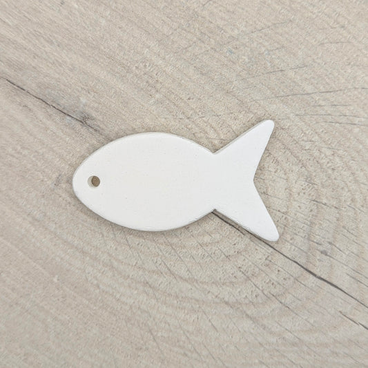 clay decoration shown against a light wood background