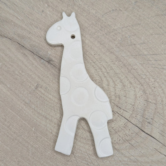 air dried clay giraffe decoration with a spot design pattern stamped into the clay