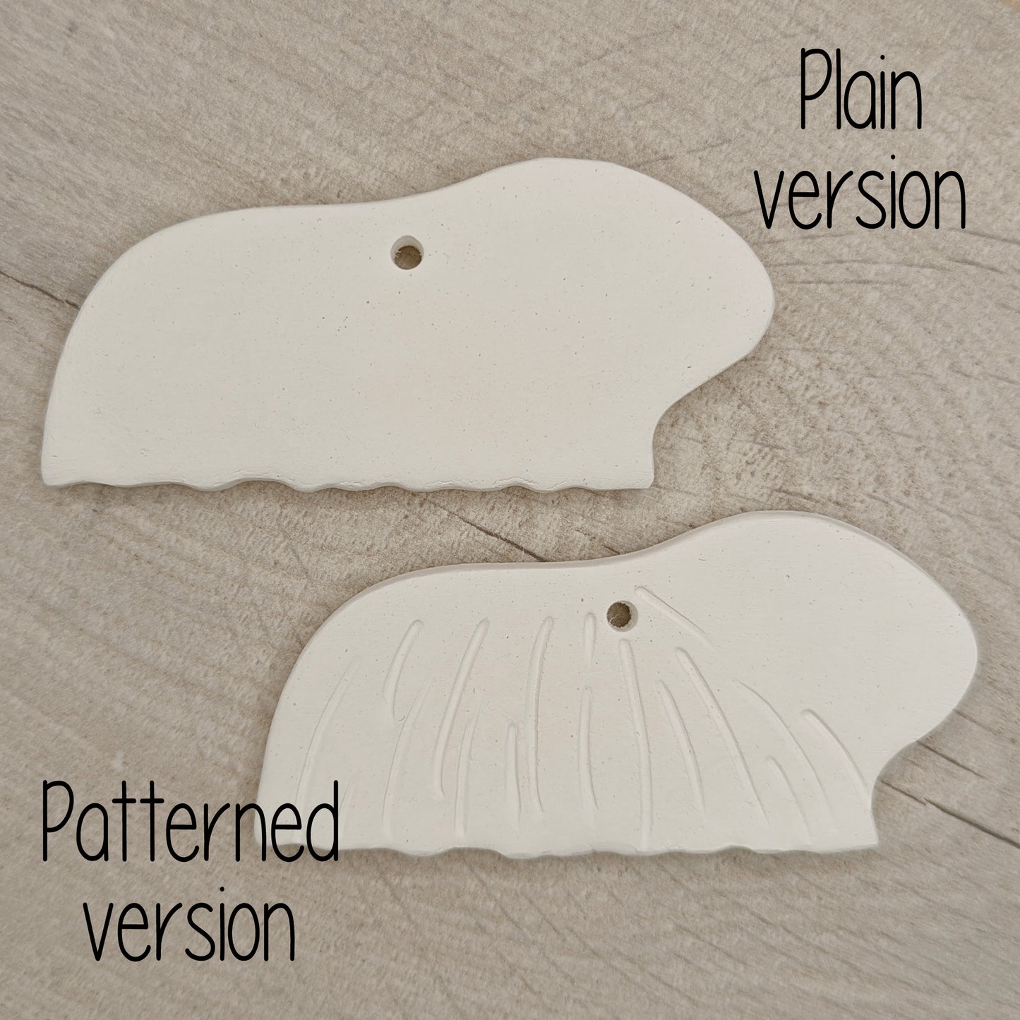 2 long haired guinea pig clay decorations, on wooden background