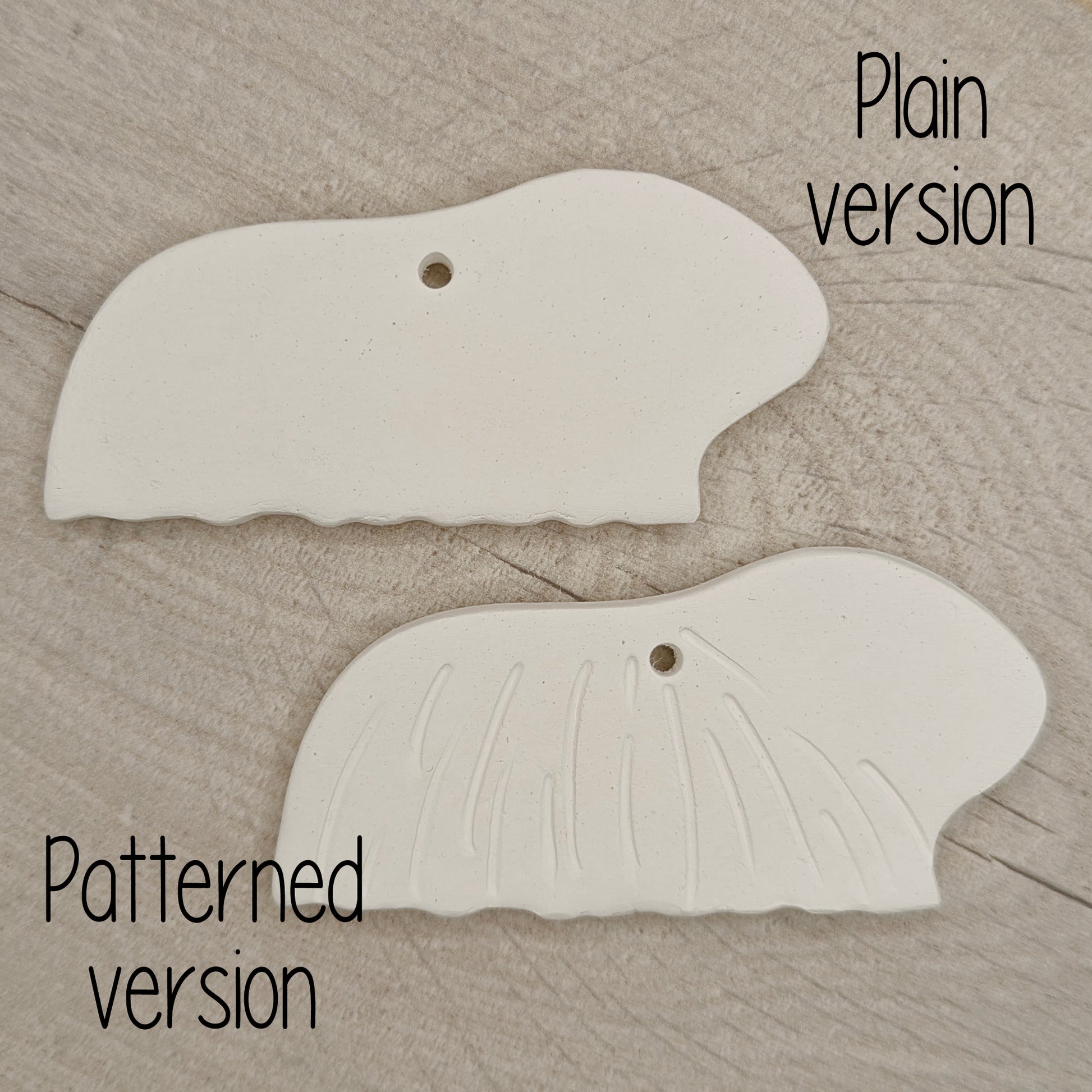 2 long haired guinea pig clay decorations, on wooden background
