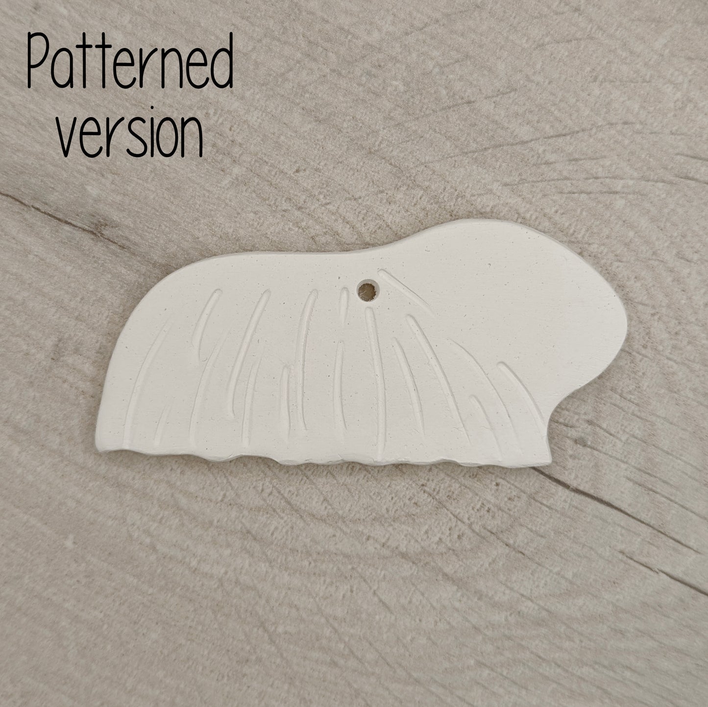 long haired guinea pig clay decoration, with hair pattern on it, on wooden background