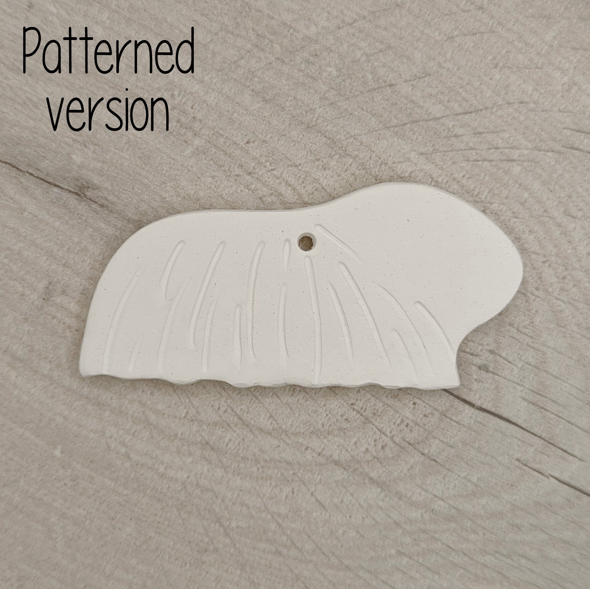 long haired guinea pig clay decoration, with hair pattern on it, on wooden background