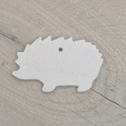 clay decoration in the shape of a hedgehog with spike details and an eye stamped in