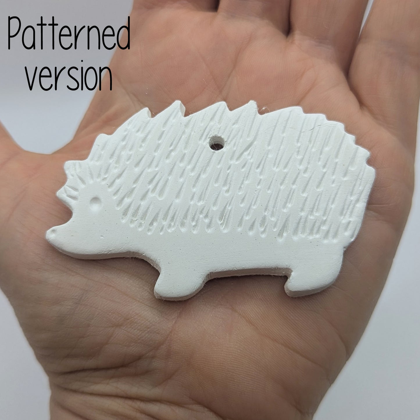 clay decoration in the shape of a hedgehog with spike details in a ladies hand to show scale