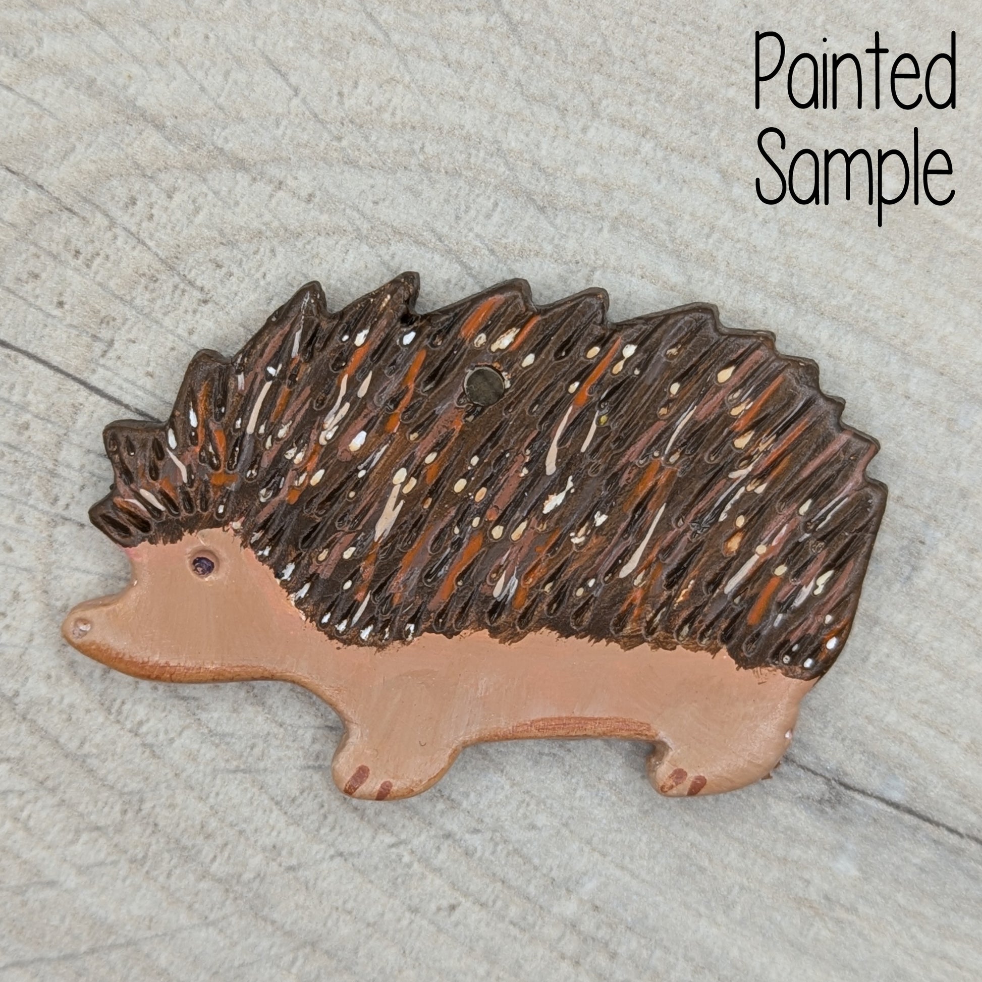 painted hedgehog clay decoration, painted in traditional brown and fawn / beige colours