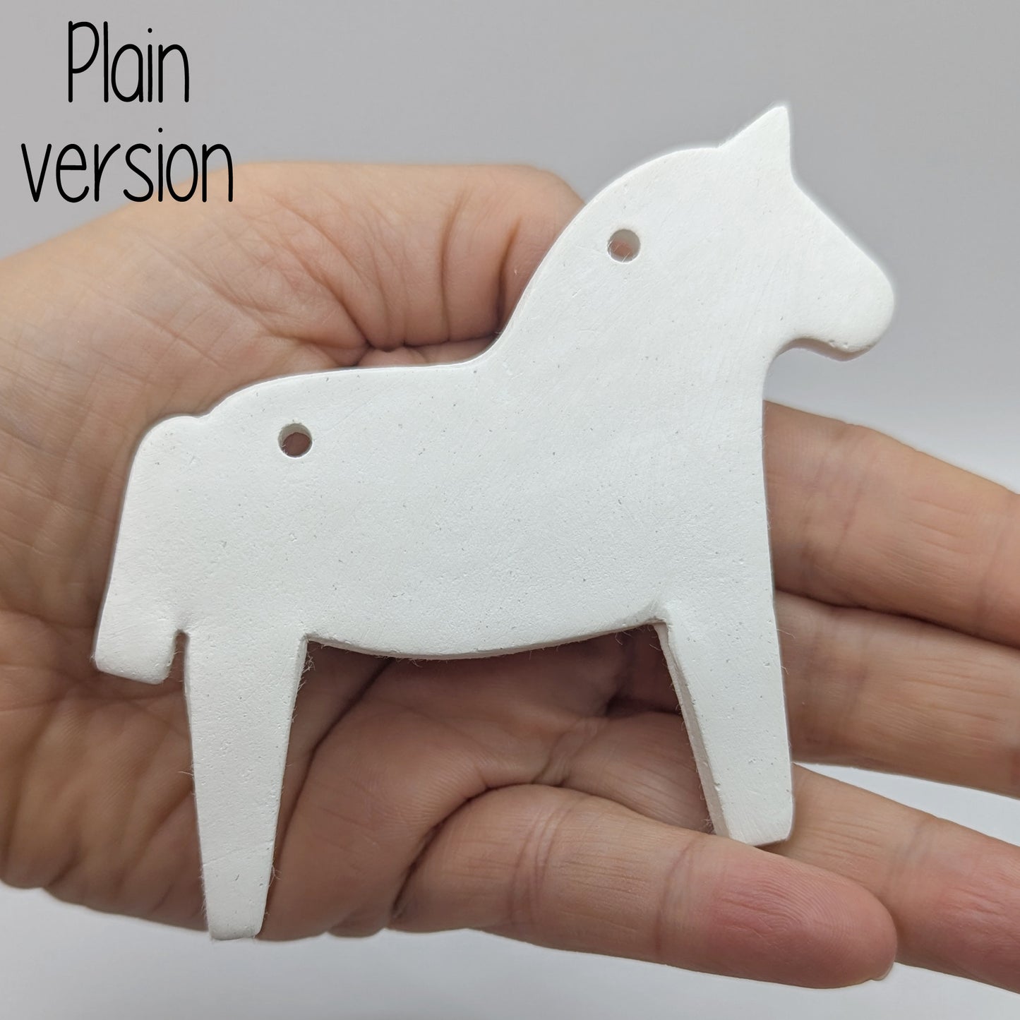 Horse shaped white clay decoration  plain version held in hand for scale
