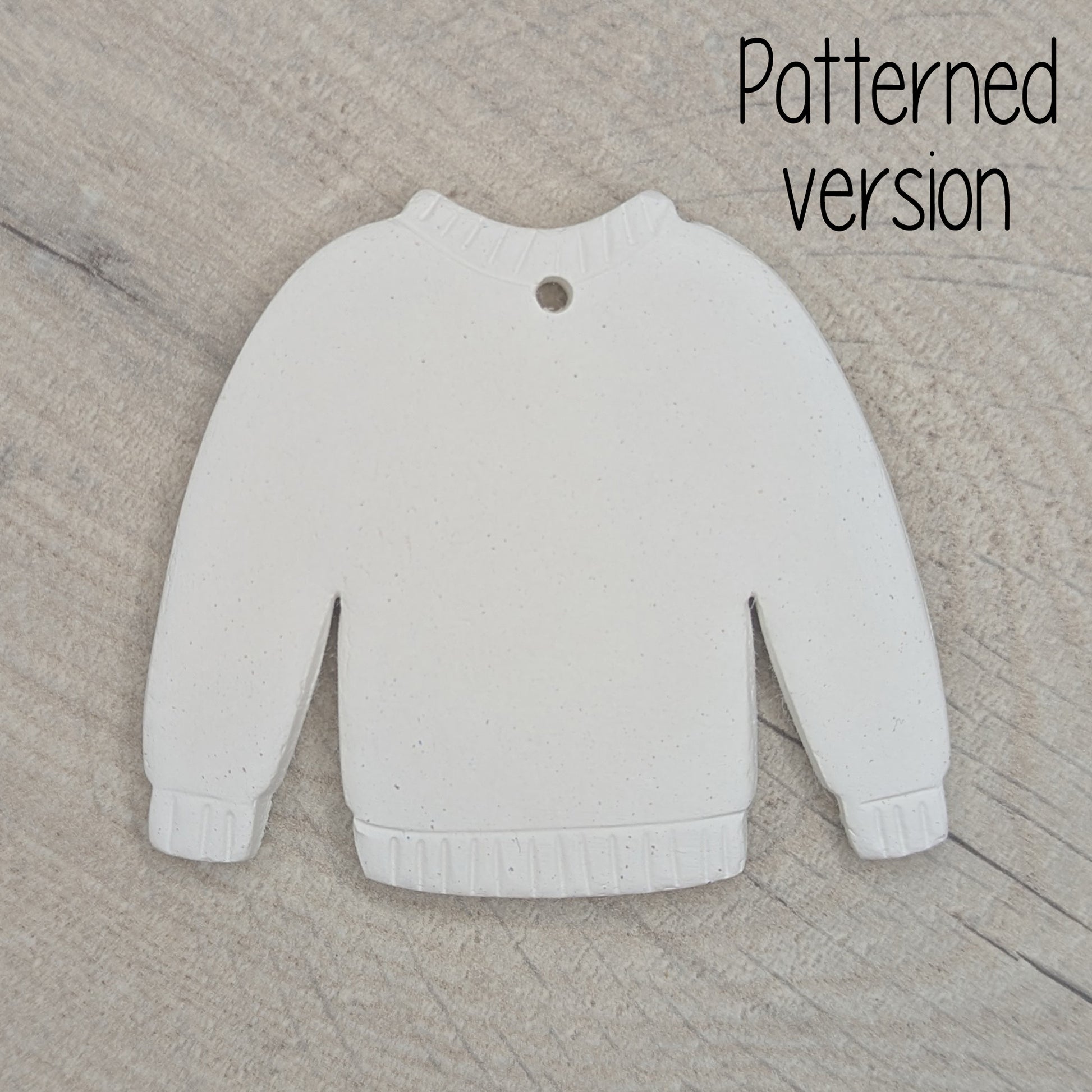 clay jumper decoration with detail / pattern around the cuffs, neck line and hem area, made of air dried clay