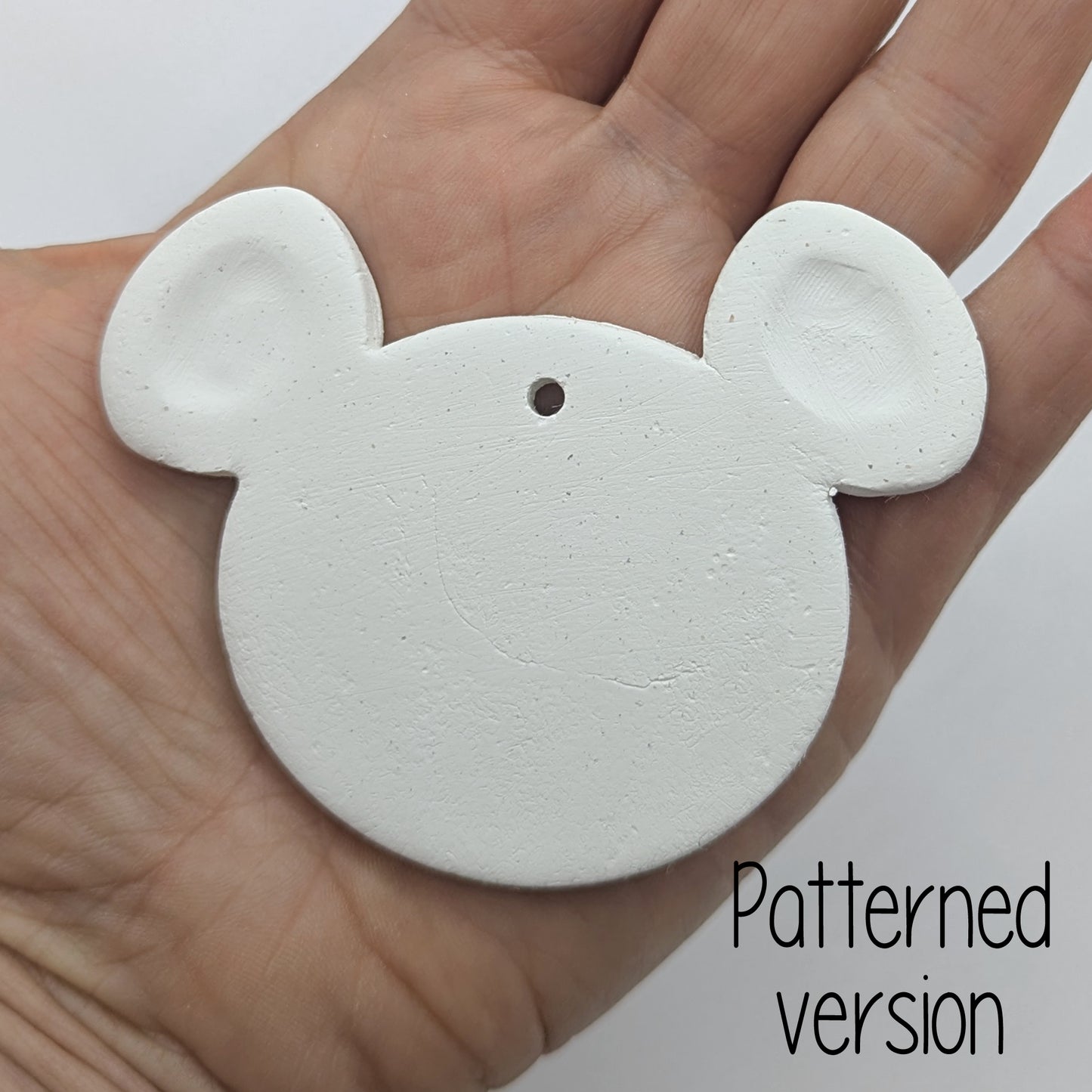 mouse or koala shaped clay decoration in a ladies hand to show scale