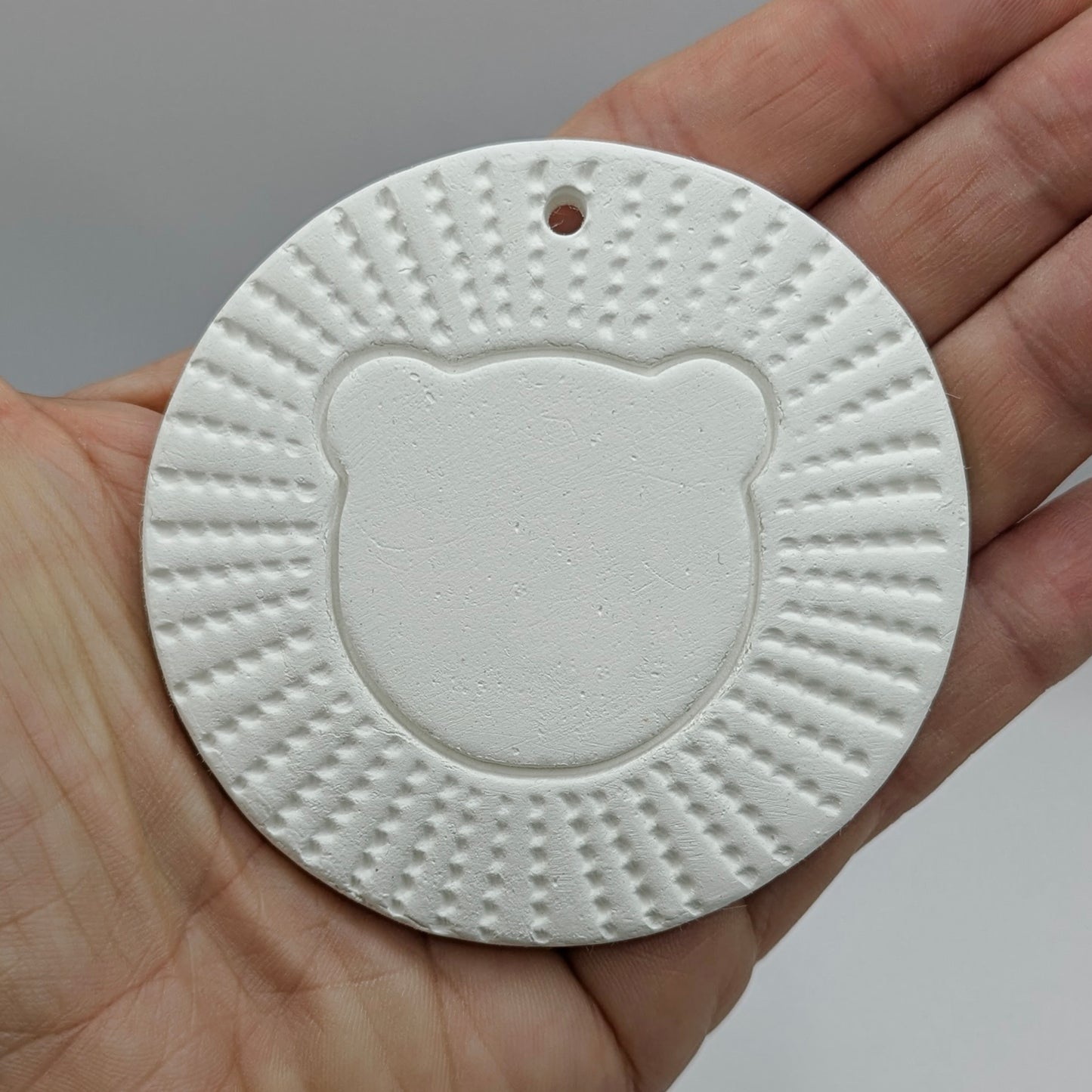 air died clay decoration in the style of a stylised lion head
