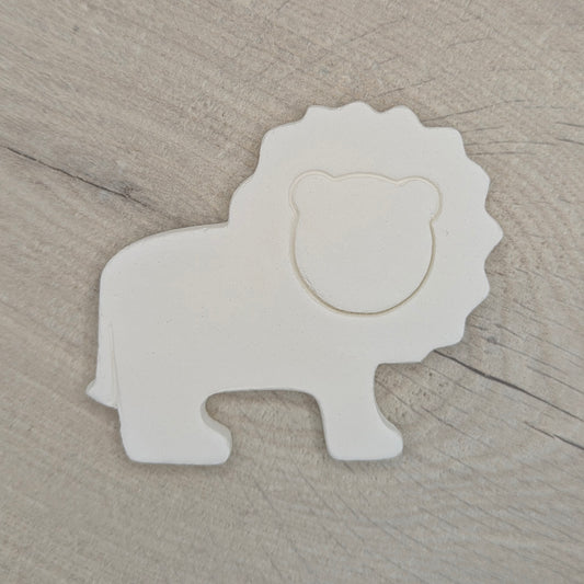 White lion-shaped decoration on a wooden surface