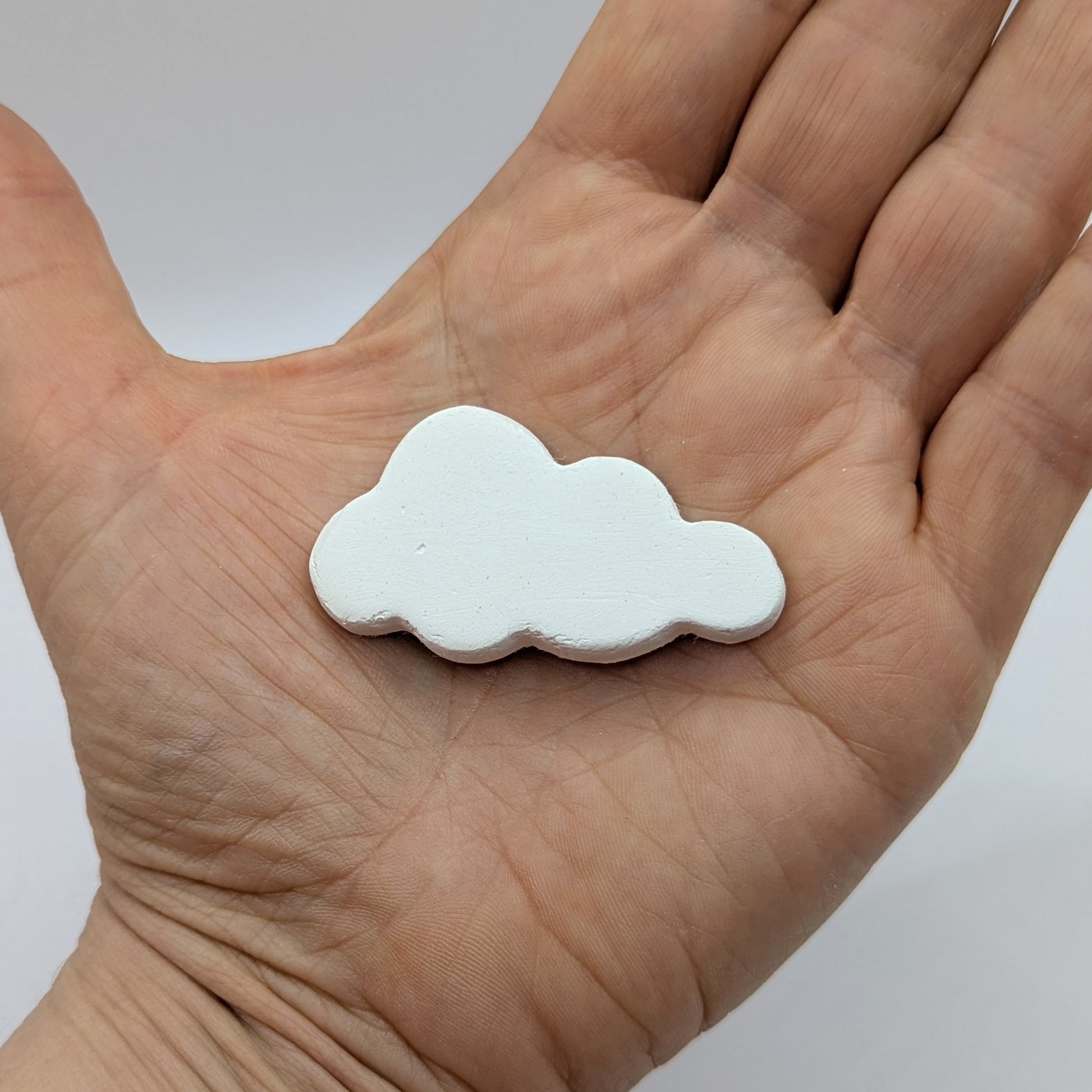 mini cloud clay decoration shown in palm of hand
