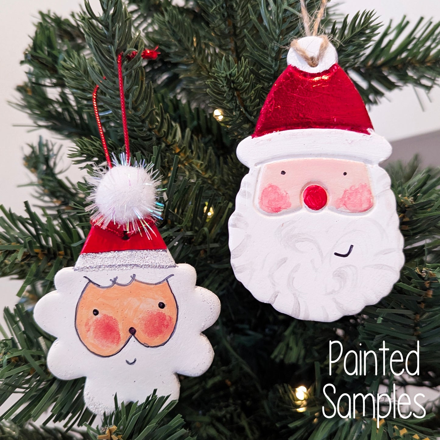 Two Santa Claus ornaments hanging on a fake Christmas tree
