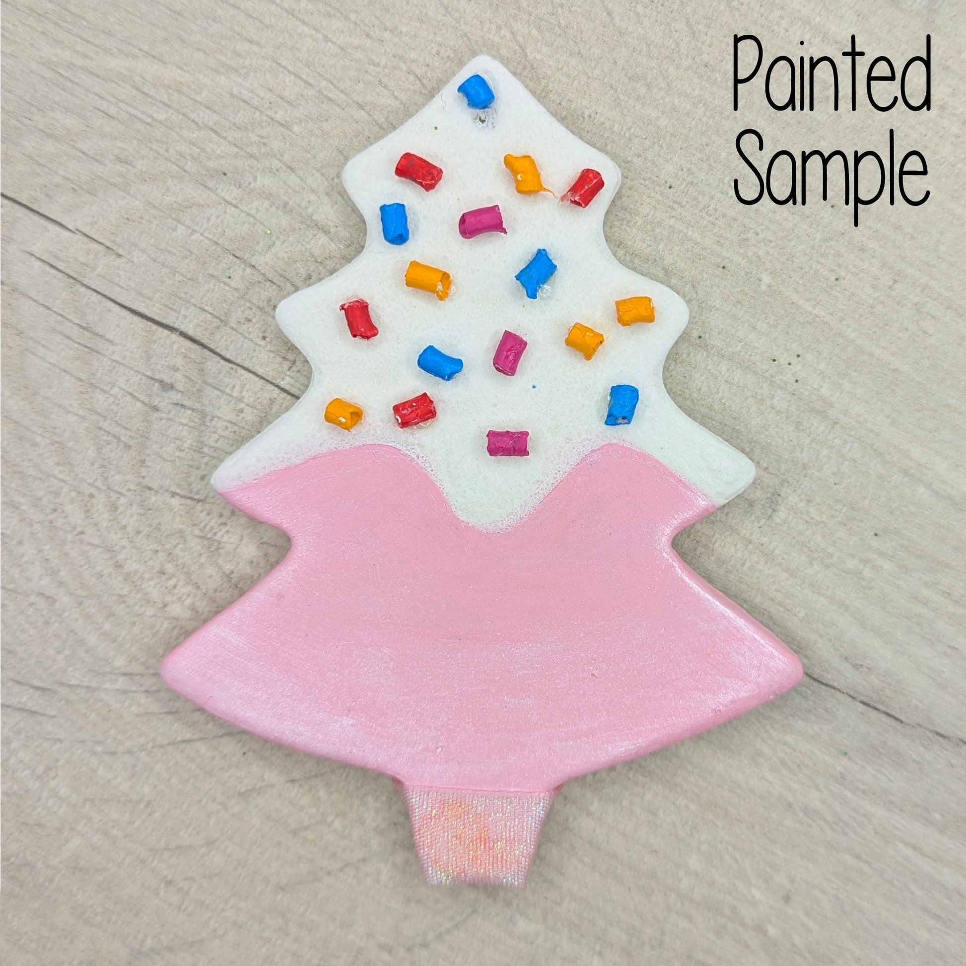 Painted christmas tree in the style of a pink donut, with multi colours sprinkles on too!