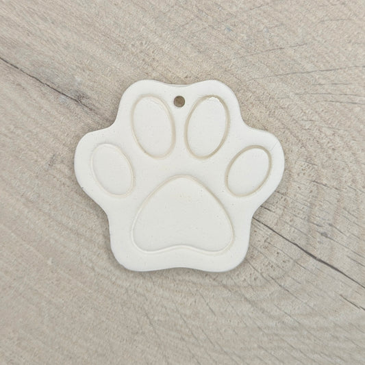 White paw print-shaped decoration on a wooden surface