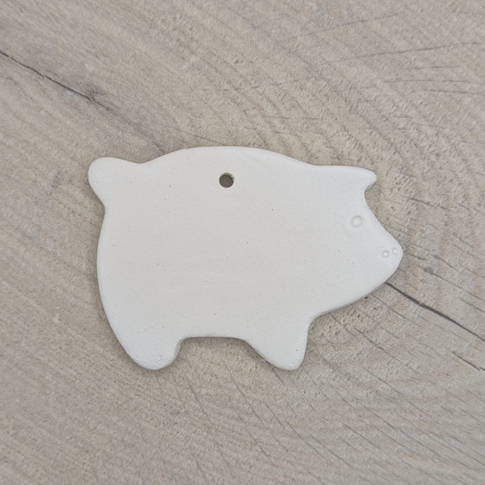 air dried clay decoration in the shape of a pig