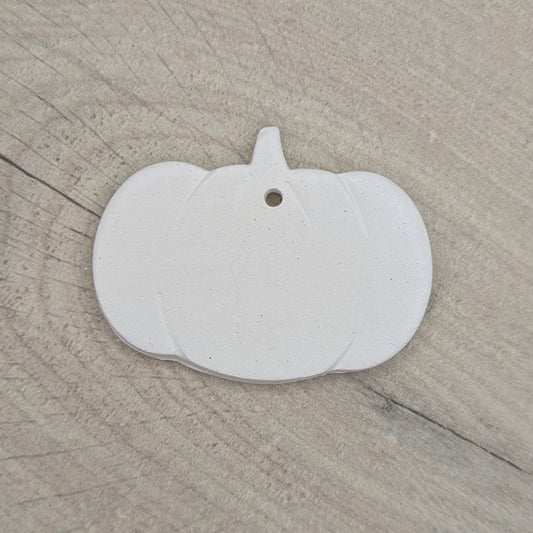White Halloween pumpkin shaped decoration on wooden background