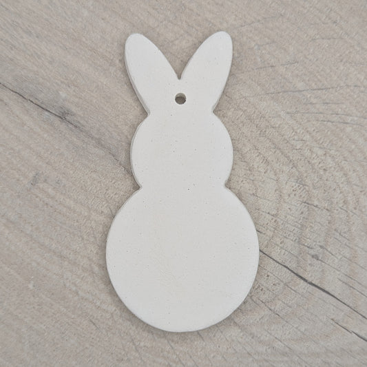 clay decoration in the shape of a rabbit, round body and head,  made of air dried clay