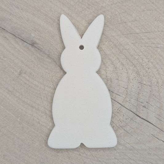 a clay decoration in the shape of a rabbit, made of air dried clay